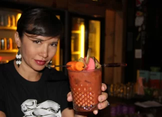 The Burrowing Owl and the Rise of the Vegan Dive Bar Burrowing Owl bartender holding a drink.