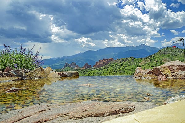 outdoor living backyard pool with garden of the gods on horizon