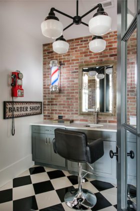 Office chair in front of a narrow white desk with a brick wall in the background