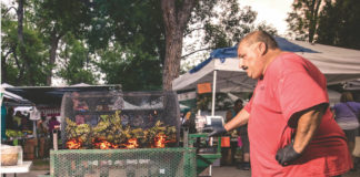 A large man roasting Pueblo chiles at the Pueblo Chile and Frijoles Festival in Pueblo, Colorado.