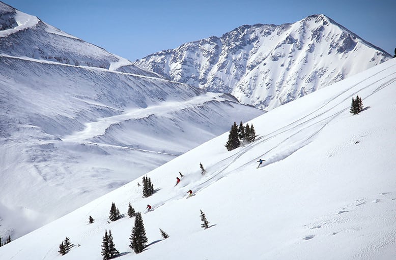cat skiing in open bowl