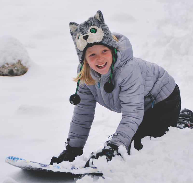 Girl having fun on a sledding hill in Colorado Springs