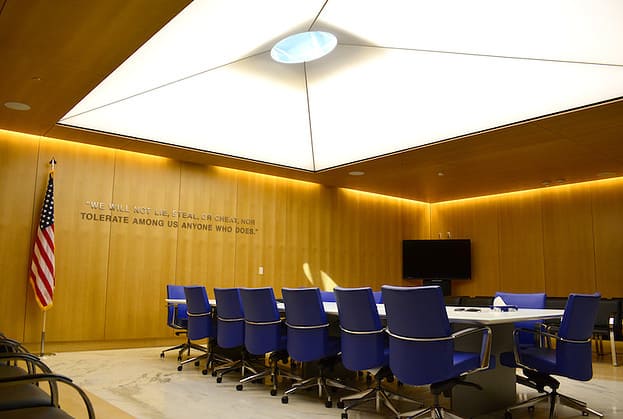 Board room with long table, skylight, and professional office chairs