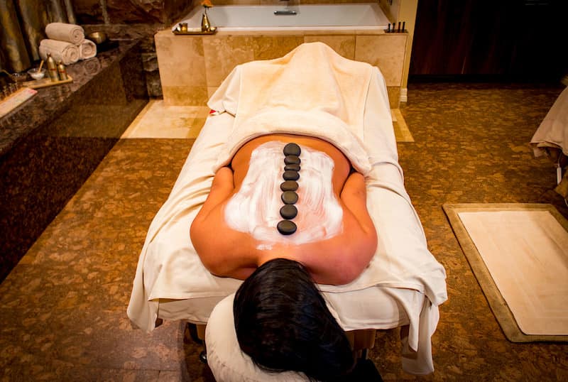 A woman enjoys a hot stone massage at the MX Spa at the Mining Exchange Hotel, where you'll find of the best spas in Colorado Springs.
