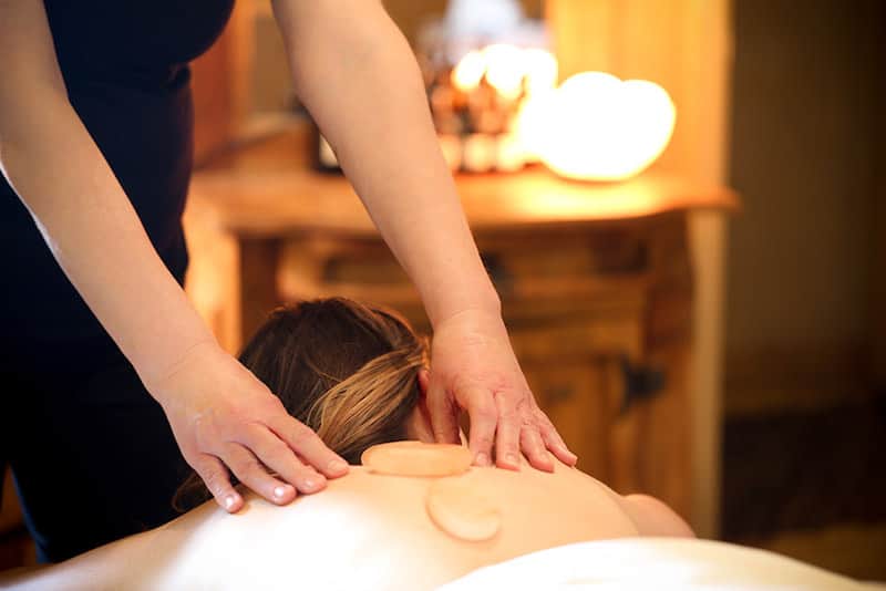 A stone massage at Meteo's Day Spa, one of the best spas in Colorado Springs.