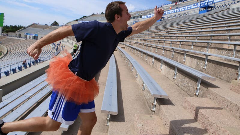 man in tutu on the stairs for Climb for Courage