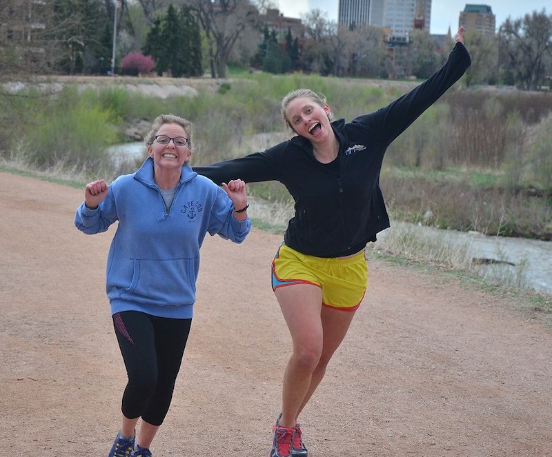 A mother and daughter cheer and run in the Jack Quinn's Running Club.
