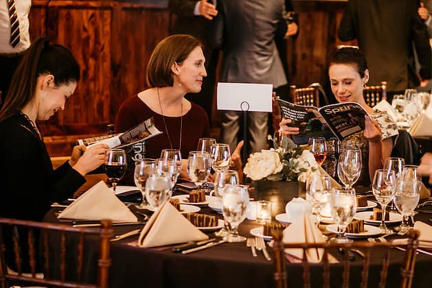 Three women at a dining table talking