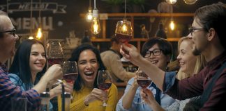 a group of people celebrating with champagne after learning how to give a toast