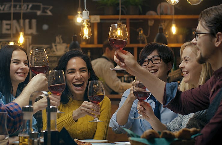 a group of people celebrating with champagne after learning how to give a toast