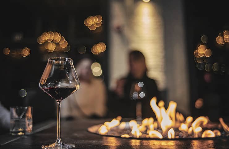 cozy hideaways wine glass and fire