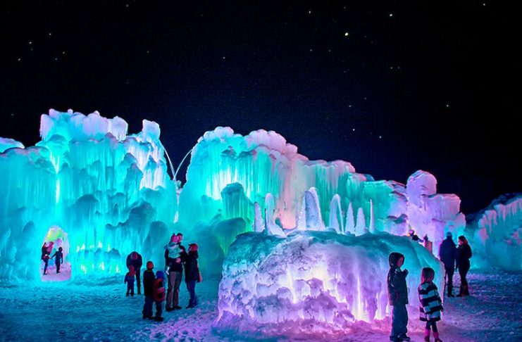 Families viewing the nearly 40-foot tall towers of Dillon Ice Castles