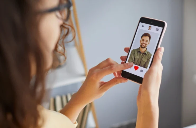 Woman swiping through a dating app on her phone