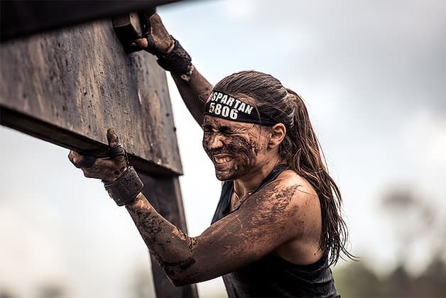 muddy woman at obstacles course races