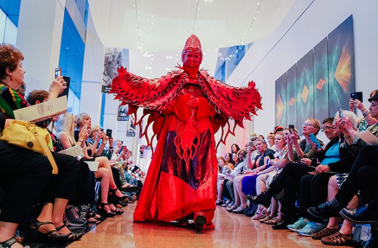 A person in a red costume walks the runway at Sashay, a fashion event at the Colorado Springs Fine Arts Center at Colorado College to celebrate the World of Wearable Art exhibition.