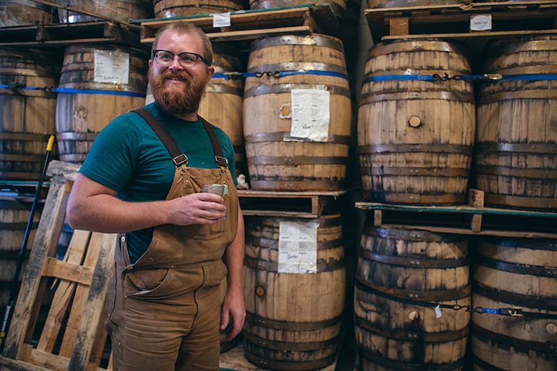 Joel Randall and barrels of State 38 Distilling blue agave spirits on the Colorado Spirits Trail