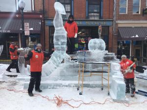 Snice Carvings team in Cripple Creek Ice Festival sculpting oversized bugs