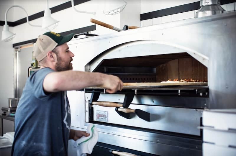 Pizza comes out of the oven at Stellina Pizza.