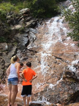 Cooling off at the base of St. Mary's Falls