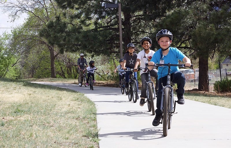 Kids ride bikes on paved path in Colorado Springs