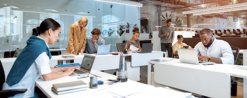 Workers in open office space. Job growth drives the recovery of the economy in Colorado Springs.