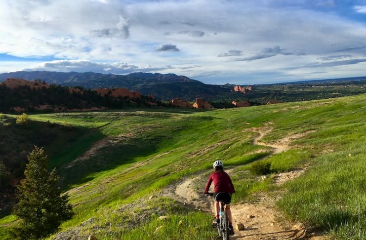 Biker rides easy mountain bikes trail in Red Rocks Canyon Open Space, Colorado Springs