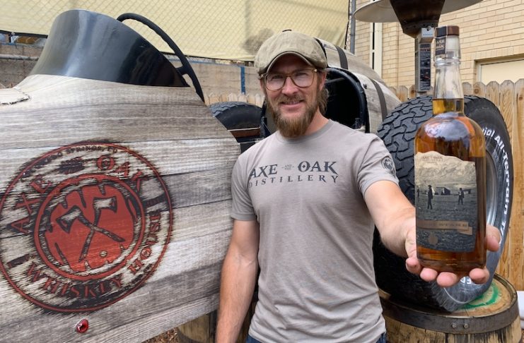 Axe and the Oak founder Casey Ross holds a bottle of The First Stake Bourbon to commemorate the Colorado Springs Sesquicentennial