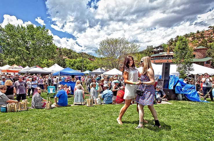 Dancing to the live music at the Manitou Springs Colorado Wine Festival with wineries in the backdrop, one of the best things to do in Colorado Springs this weekend.