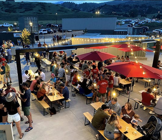 15 Favorite Patios and Outdoor Dining Restaurants in Colorado Springs Red Leg Brewing patio under the string lights
