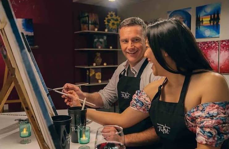 A couple paints during date night at Painting With a Twist in Colorado Springs