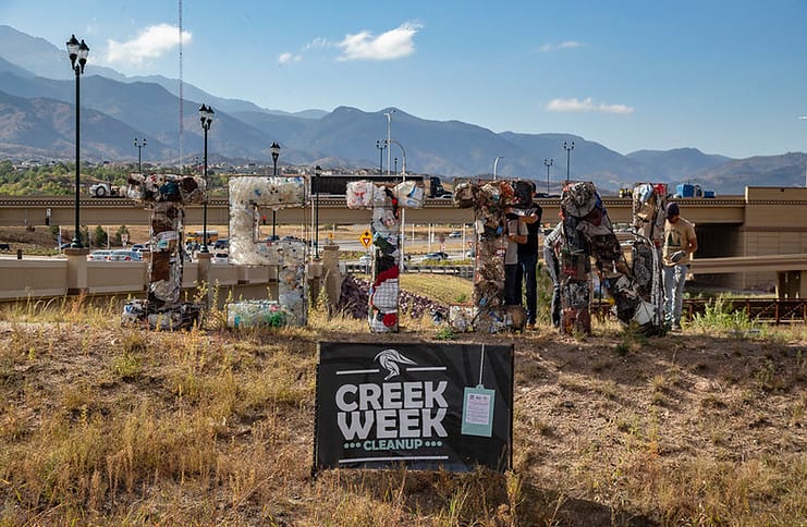volunteers setting up an artisitc display for creek week