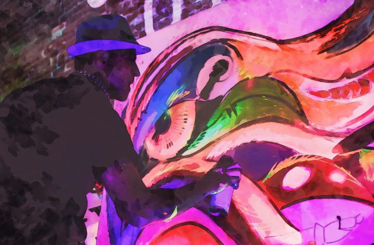 Arts Month photo of Jaguart Deco painting a mural