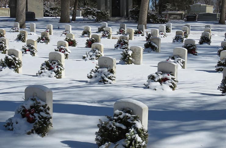 tombstones in a cemetery blanketed with snow
