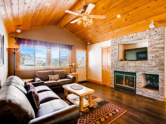 Warm living area with stone-framed fireplace.