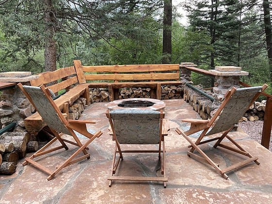 outdoor fire pit on stone deck at twin pines cabins in colorado springs