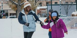 black mom and daughter holding hands while ice skating in colorado springs