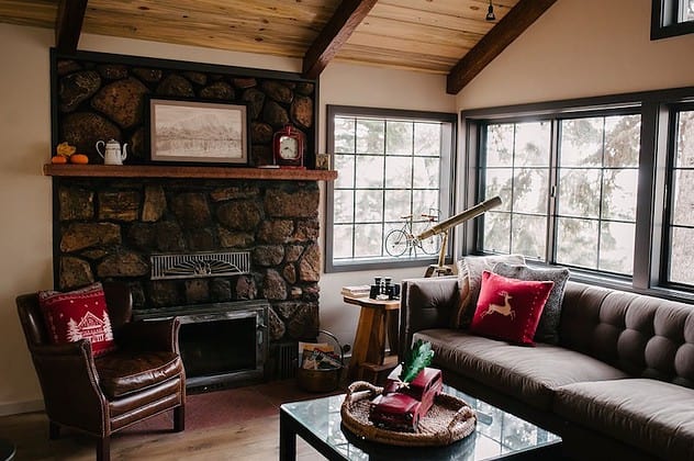 The fireplace and living room at the Cabin in the Pines cabin getaway colorado springs