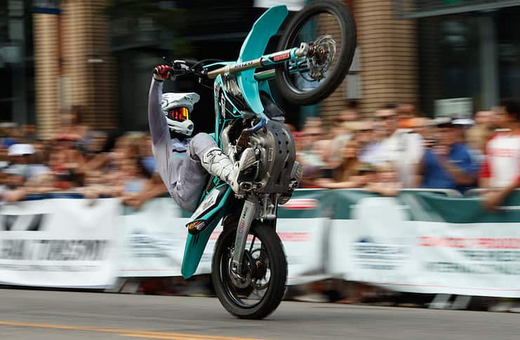 Motorcycle wheelie at Fan Fest for the Broadmoor Pikes Peak International Hill Climb in Colorado Springs