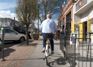 Exploring the Visual Arts in Colorado Springs Andy Vick riding around town on a bike