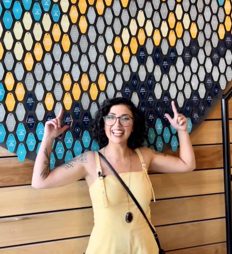 Jasmine Dillavou highlights some of the hip decor at Kinship Landing in downtown Colorado Springs.