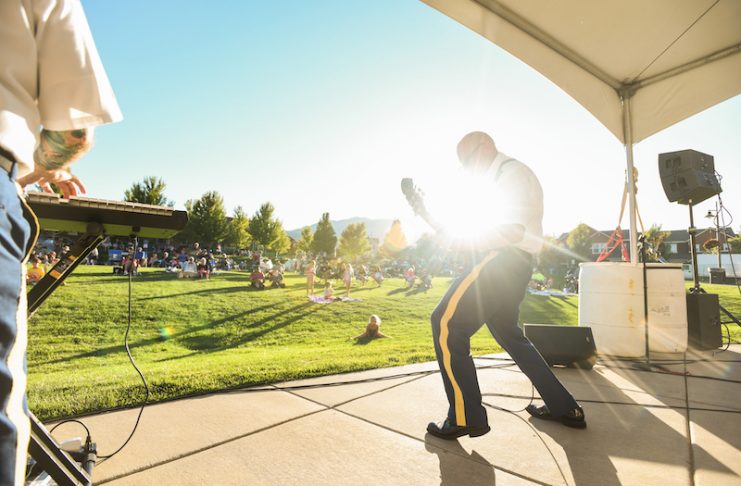 Guitarist with sunburst plays onstage at Music on the Mesa concert at Gold Hill Mesa in Colorado Springs