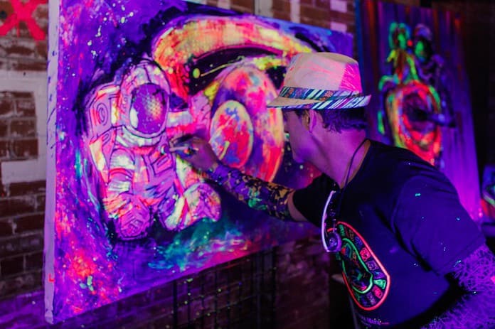 Live art experience as Diego Jaguart paints with fluorescent paint