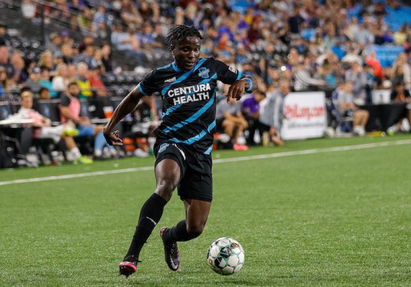 Switchbacks soccer player Michee Ngalina dribbles the ball on the field