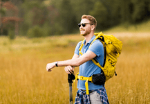 Man enjoying a brisk hike on a sunny day.