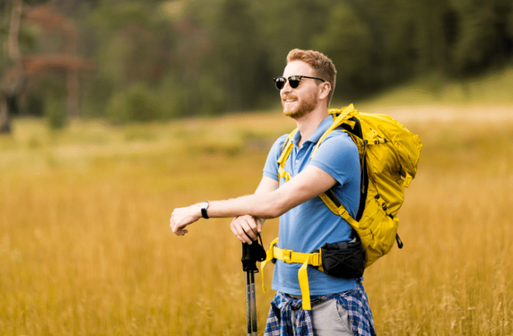 Man enjoying a brisk hike on a sunny day.