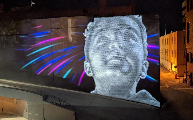 Mural portrait of child by El Mac in AdAmAn Alley in Colorado Springs