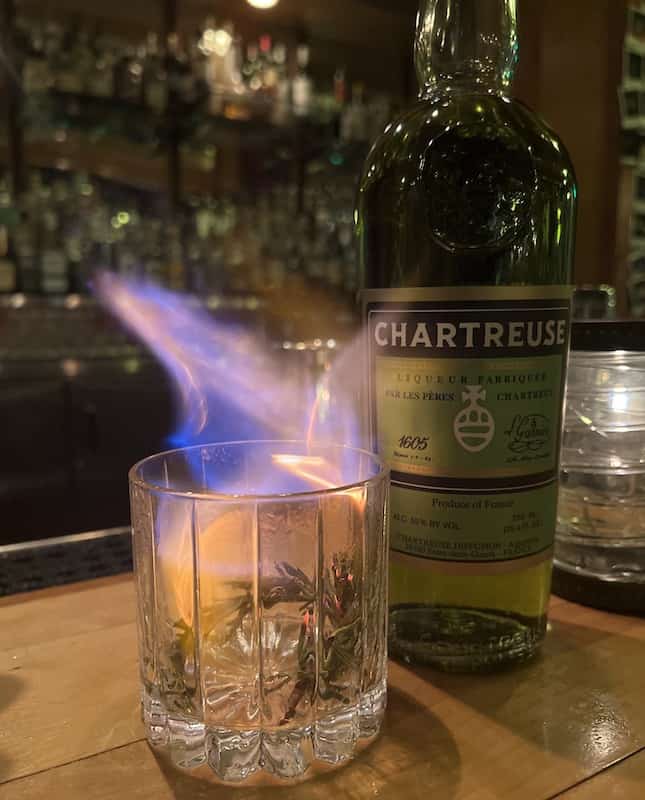 Flames dance above the glass of the Rubicon, a winter cocktail at The Archives in Colorado Springs.