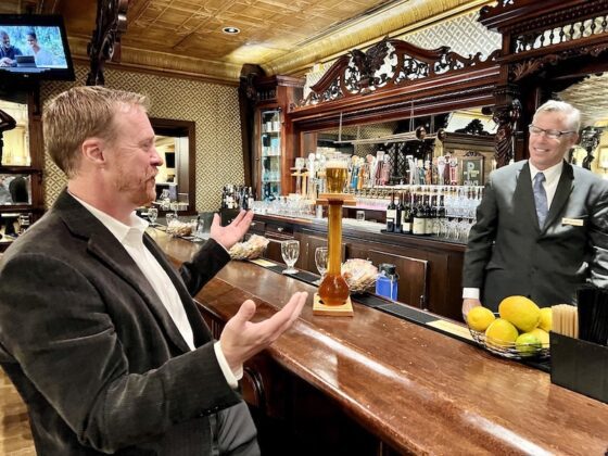 Nathan Newbrough of the Colorado Springs Philharmonic admires a half yard of ale at the Golden Bee, the English pub at The Broadmoor.