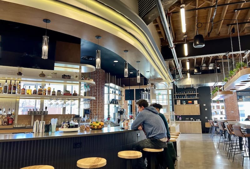 The curving bar of Gift Horse Bar and Cafe at The Well food hall in Colorado Springs