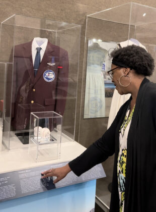 Lynne Hastings explores a jacket worn by a local Tuskegee Airman at the Colorado Springs Pioneers Museum.